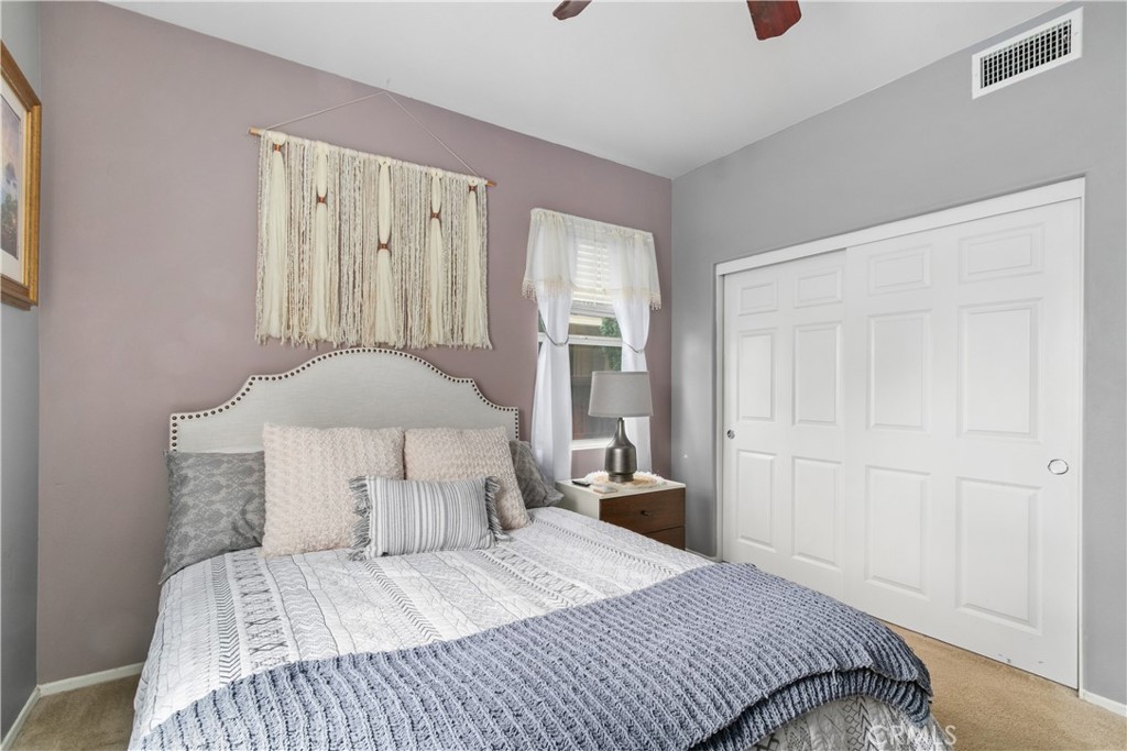 37192 High Ridge Drive Beaumont, CA 92223 - Photo 21 of 71 a bedroom with a bed and a lamp