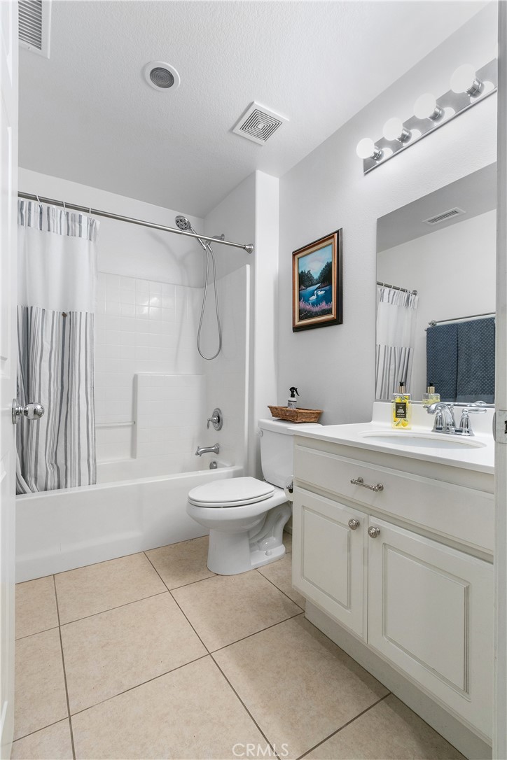 37192 High Ridge Drive Beaumont, CA 92223 - Photo 23 of 71 a bathroom with a toilet a sink a mirror and a shower