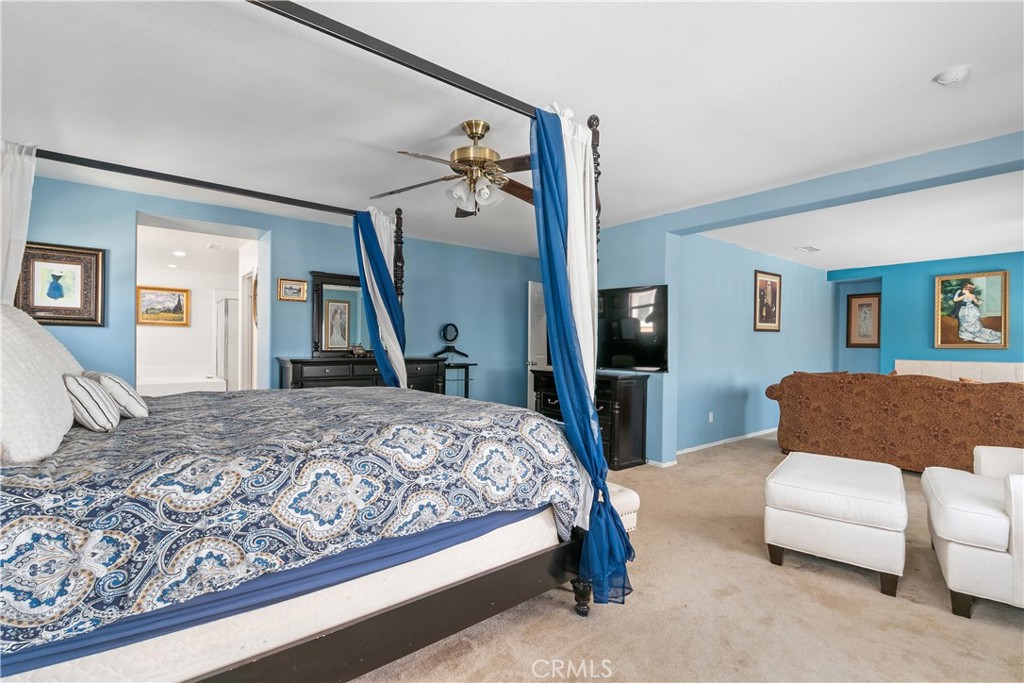 37192 High Ridge Drive Beaumont, CA 92223 - Photo 29 of 71 a bedroom with a bed couch and a flat screen tv