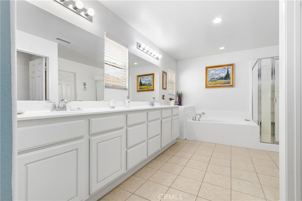 37192 High Ridge Drive Beaumont, CA 92223 - Photo 31 of 71 a spacious bathroom with a double vanity sink a mirror a bathtub and a shower