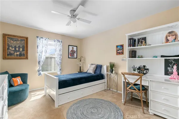 a dining room with furniture a rug and a floor to ceiling window