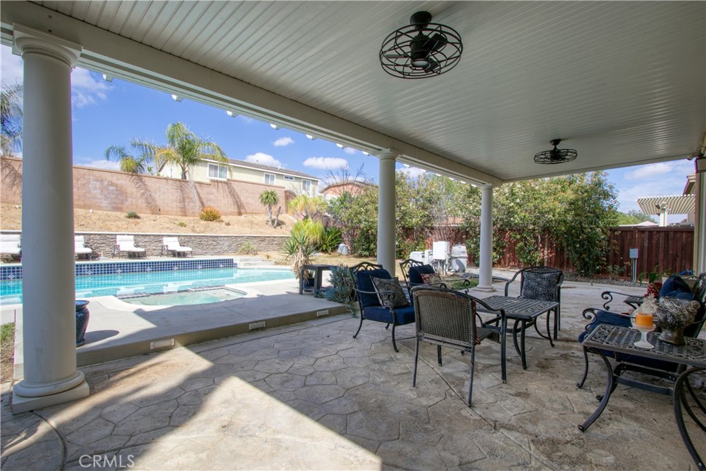 37192 High Ridge Drive Beaumont, CA 92223 - Photo 49 of 71 a dining room with furniture a rug and a floor to ceiling window