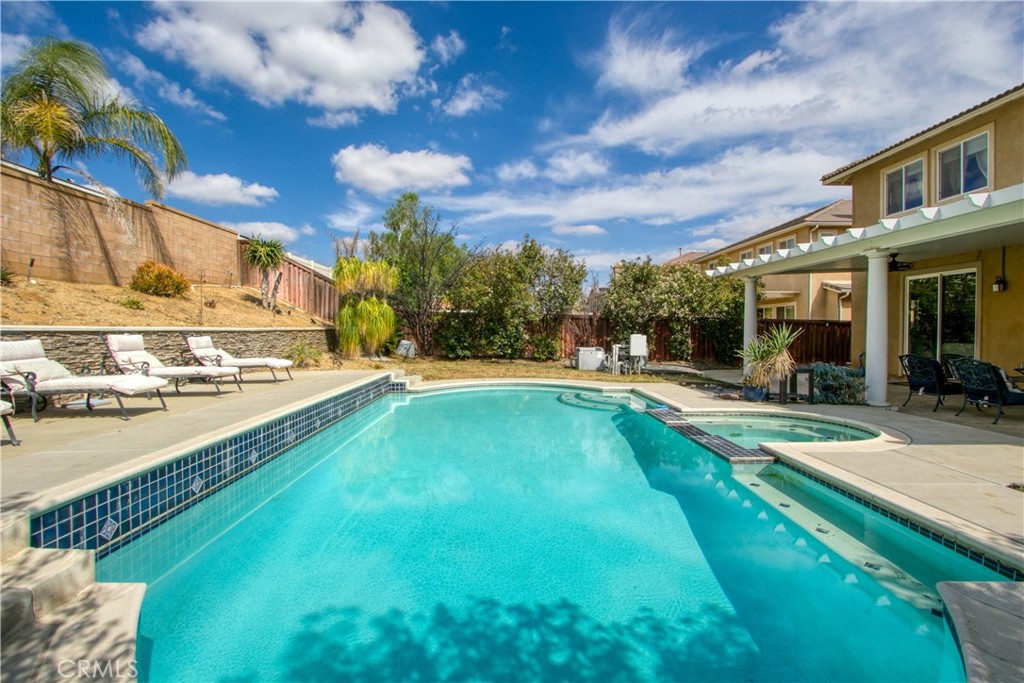 37192 High Ridge Drive Beaumont, CA 92223 - Photo 52 of 71 a swimming pool with outdoor seating and yard