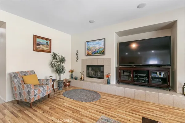 a living room with furniture a flat screen tv and a fireplace