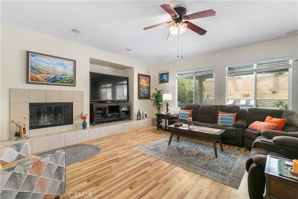 37192 High Ridge Drive Beaumont, CA 92223 - Photo 7 of 71 a living room with furniture a flat screen tv and a fireplace