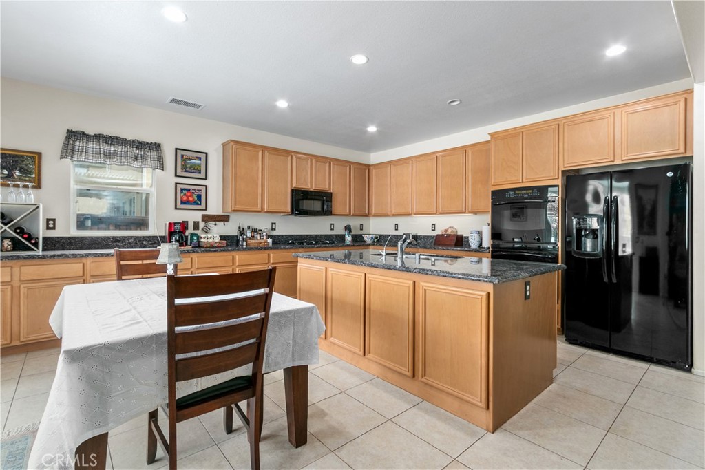 37192 High Ridge Drive Beaumont, CA 92223 - Photo 9 of 71 a kitchen with stainless steel appliances granite countertop a refrigerator and a stove top oven
