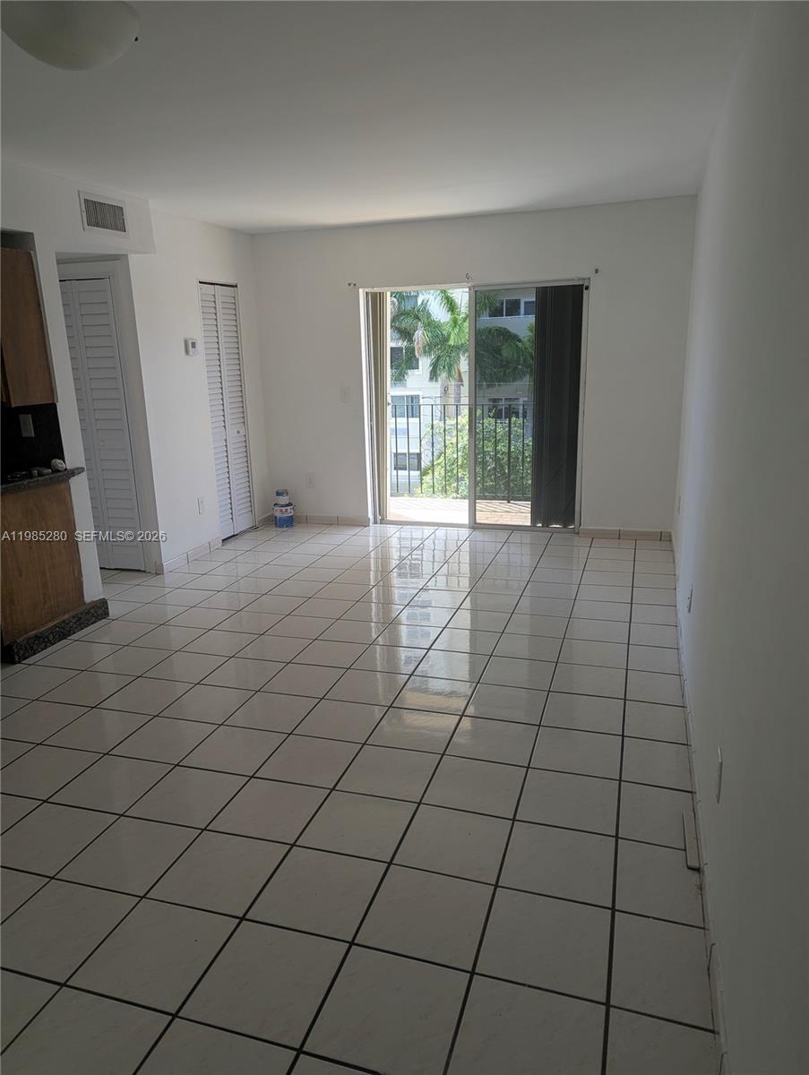 a view of an empty room and a window