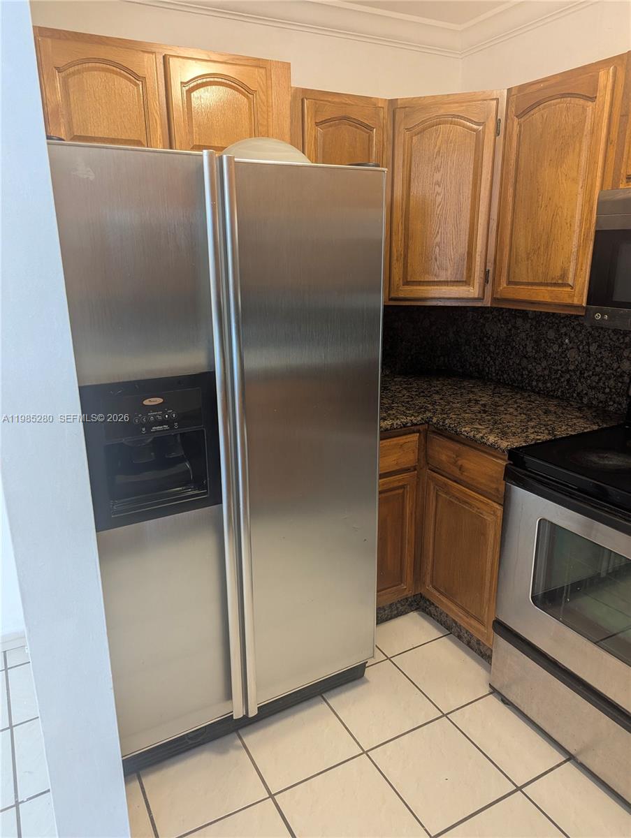 1051 Southwest 1st Street, Unit 411 Miami, FL 33130 - Photo 3 of 8 a kitchen with metallic refrigerator and microwave