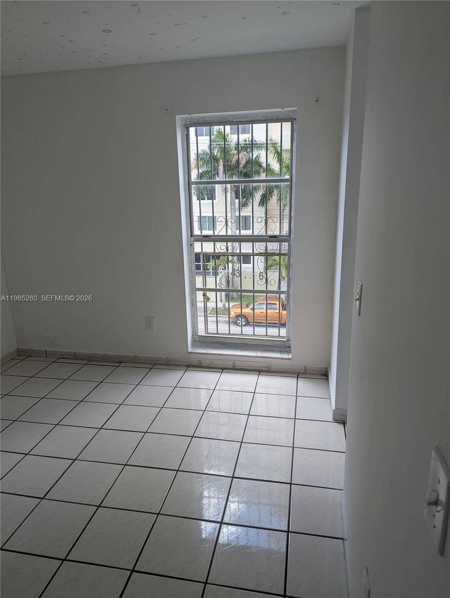 1051 Southwest 1st Street, Unit 411 Miami, FL 33130 - Photo 5 of 8 a view of an empty room and window