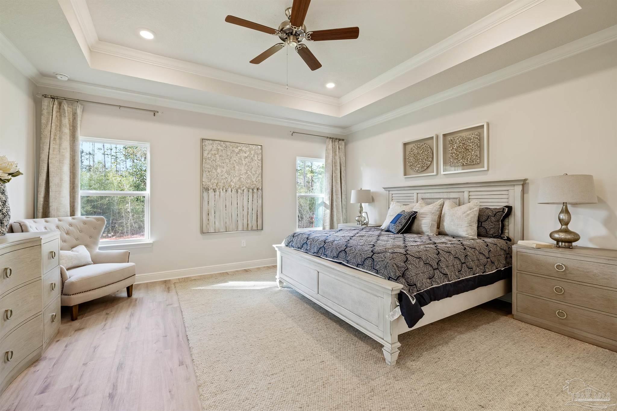 435 Connie Way Cantonment, FL 32533 - Photo 12 of 17 a spacious bedroom with a bed and a couch