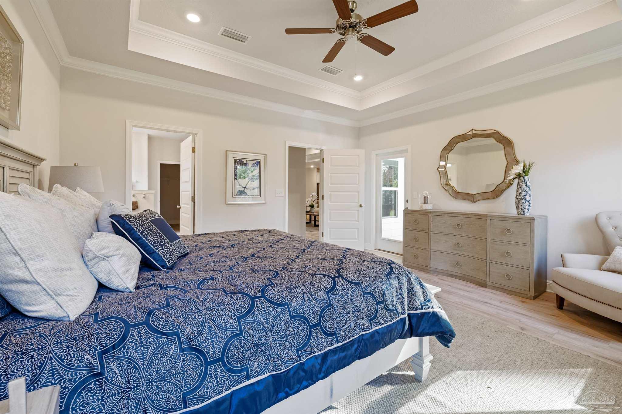 435 Connie Way Cantonment, FL 32533 - Photo 13 of 17 a bedroom with a large bed and a chandelier