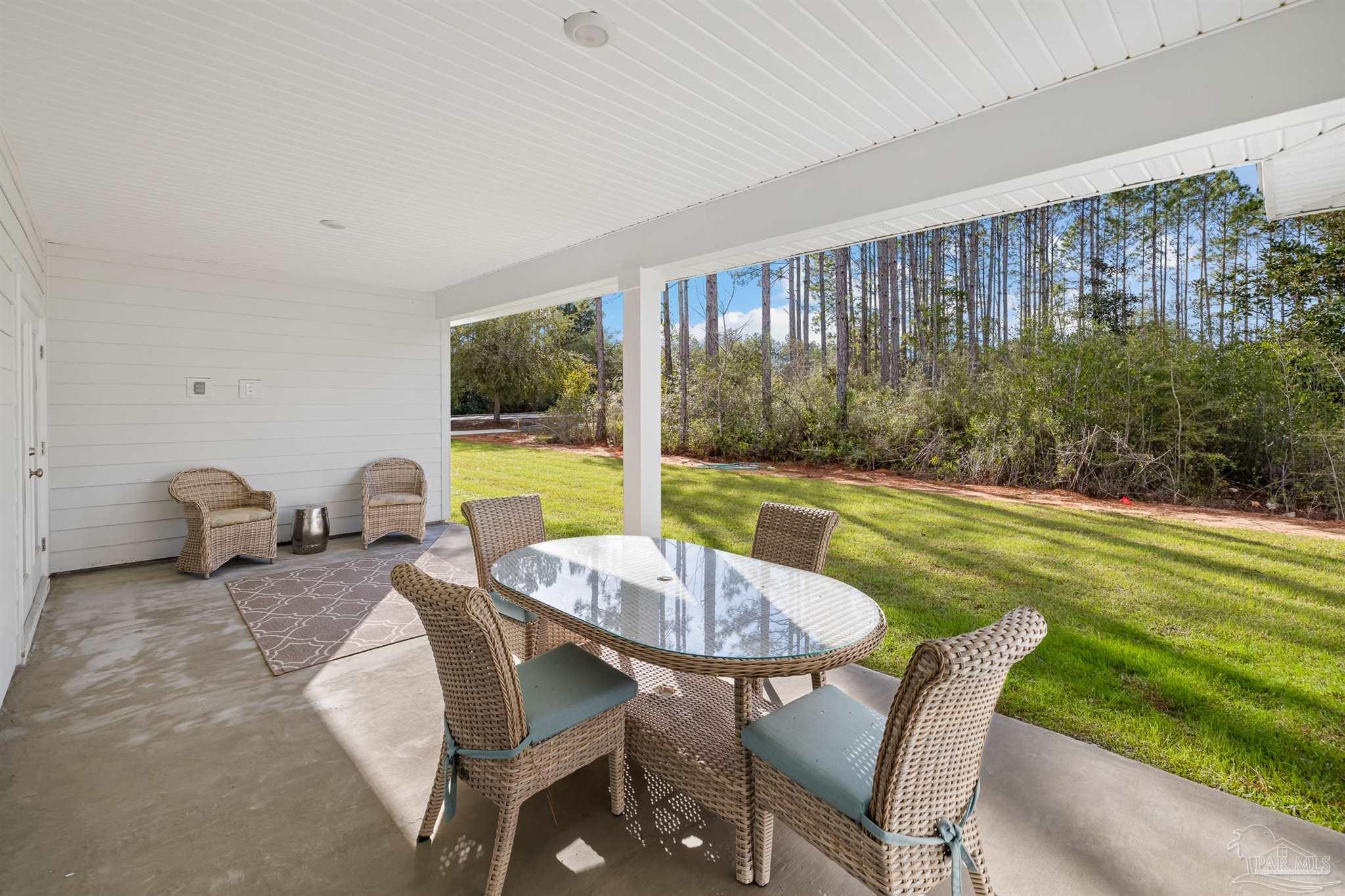 435 Connie Way Cantonment, FL 32533 - Photo 15 of 17 a dining room with furniture and a garden