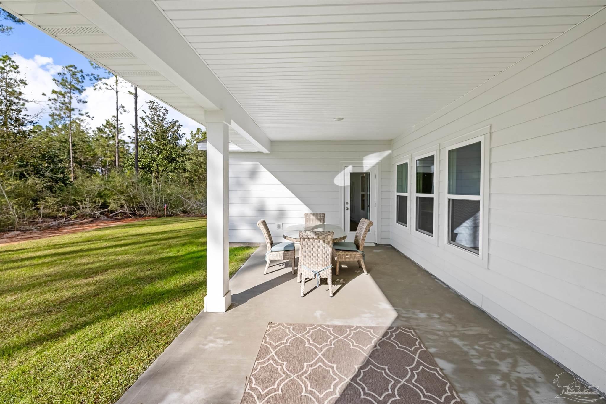435 Connie Way Cantonment, FL 32533 - Photo 16 of 17 a house view with a sitting space and garden space
