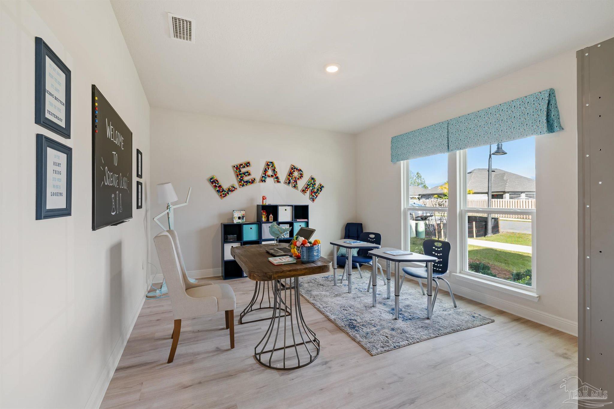 435 Connie Way Cantonment, FL 32533 - Photo 5 of 17 a work room with furniture and a window