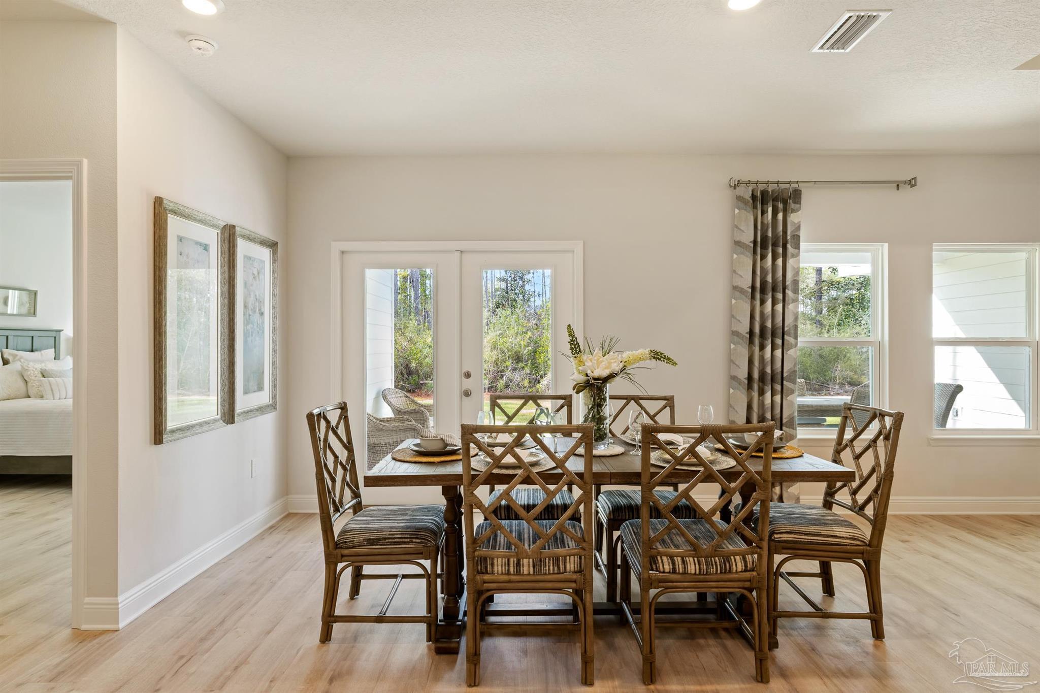 435 Connie Way Cantonment, FL 32533 - Photo 9 of 17 a view of a dining room with furniture and wooden floor