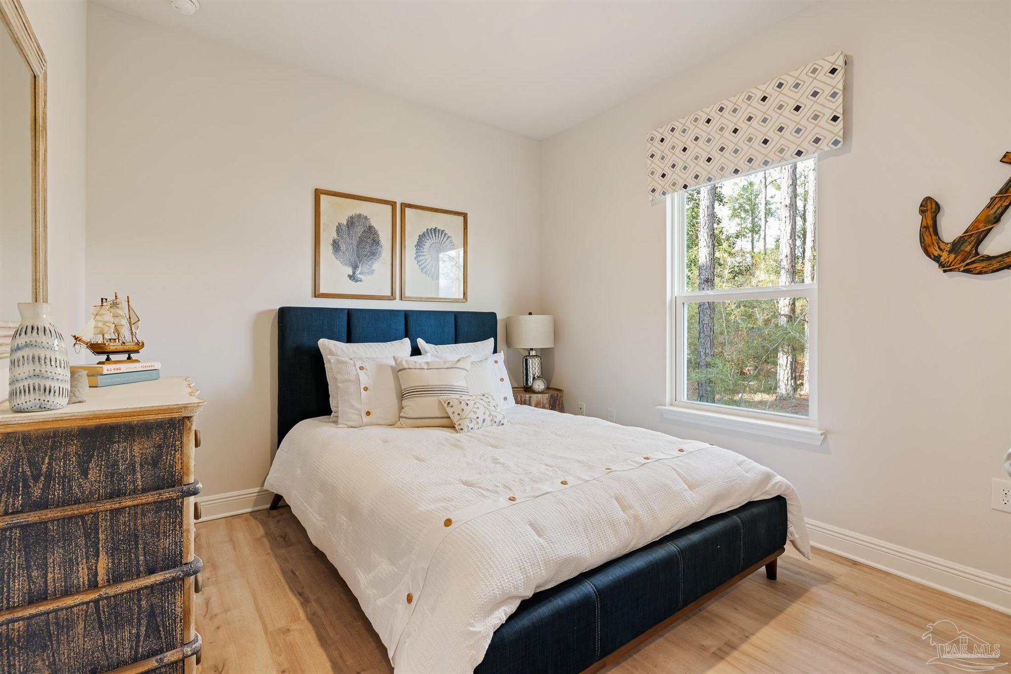 435 Connie Way Cantonment, FL 32533 - Photo 10 of 17 a bedroom with a bed and a window