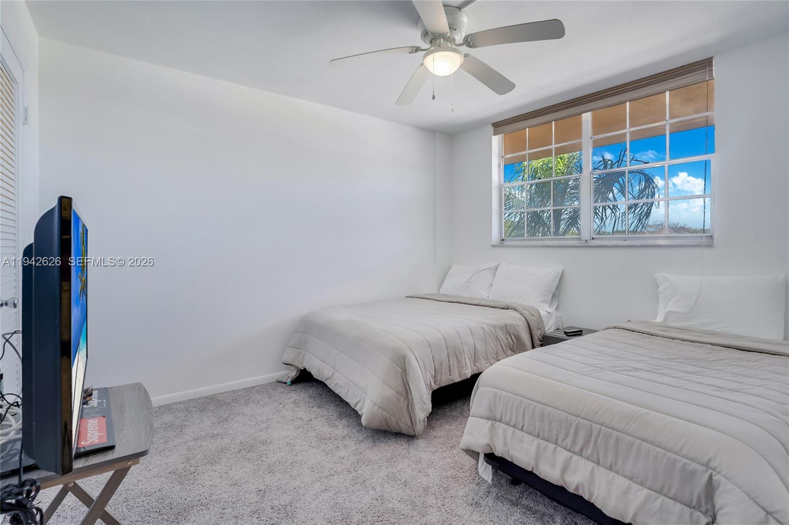 4502 North Federal Highway, Unit 334D Lighthouse Point, FL 33064 - Photo 12 of 15 a bedroom with two beds and a window