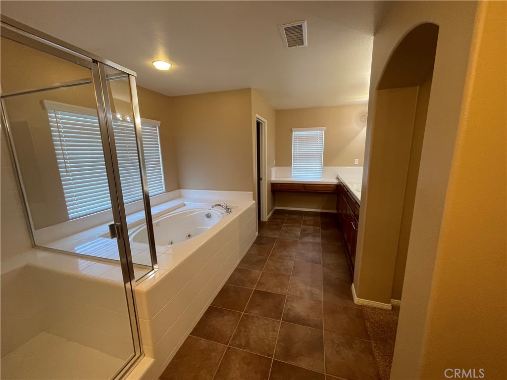 42249 CLAIRISSA Way Murrieta, CA 92562 - Photo 25 of 47 a bathroom with a tub and shower
