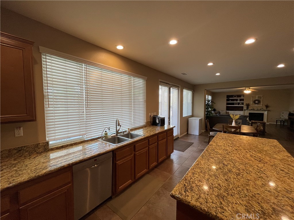 42249 CLAIRISSA Way Murrieta, CA 92562 - Photo 33 of 47 a large kitchen with kitchen island a sink stainless steel appliances wooden floor and counter space