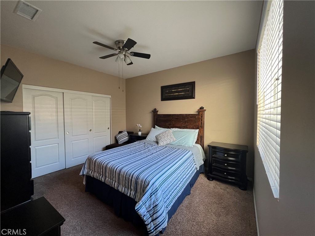 42249 CLAIRISSA Way Murrieta, CA 92562 - Photo 36 of 47 a bedroom with a bed and a ceiling fan