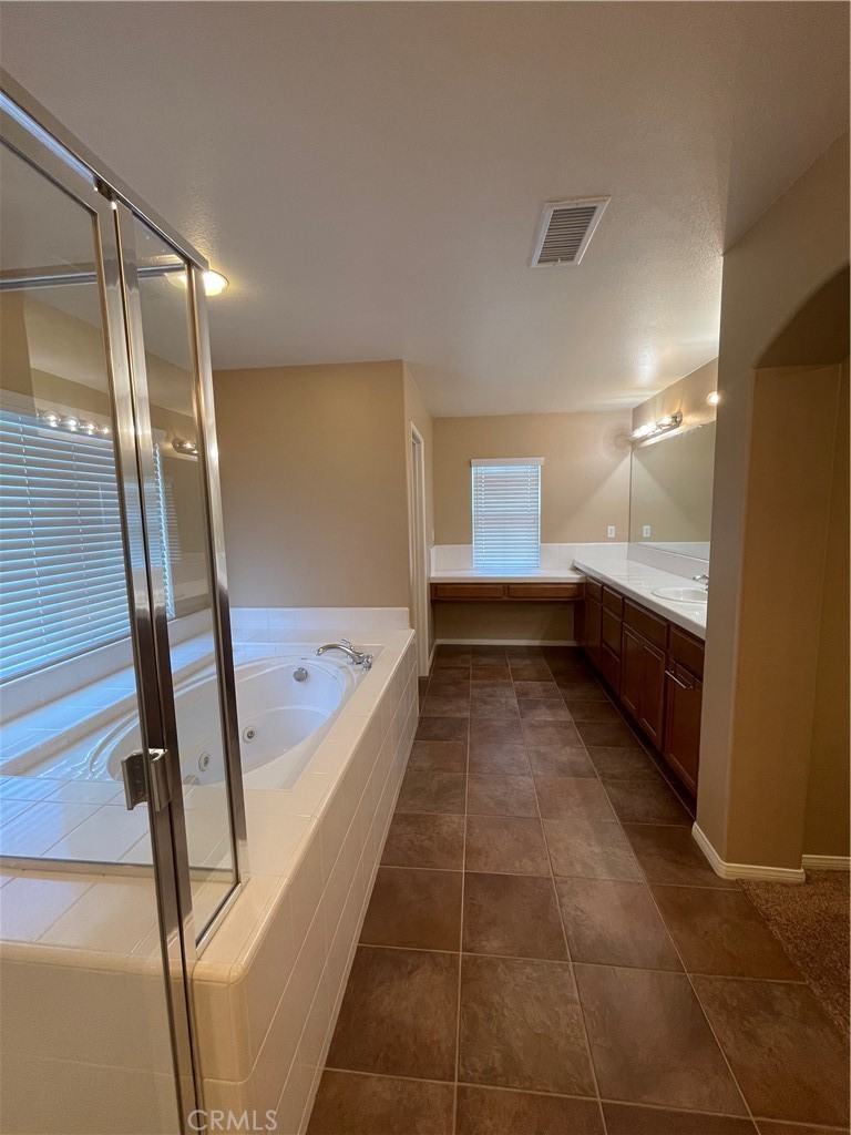 42249 CLAIRISSA Way Murrieta, CA 92562 - Photo 38 of 47 a bathroom with a bathtub and a shower