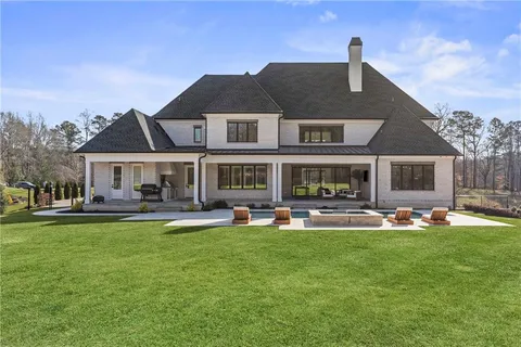 a front view of a house with swimming pool having outdoor seating