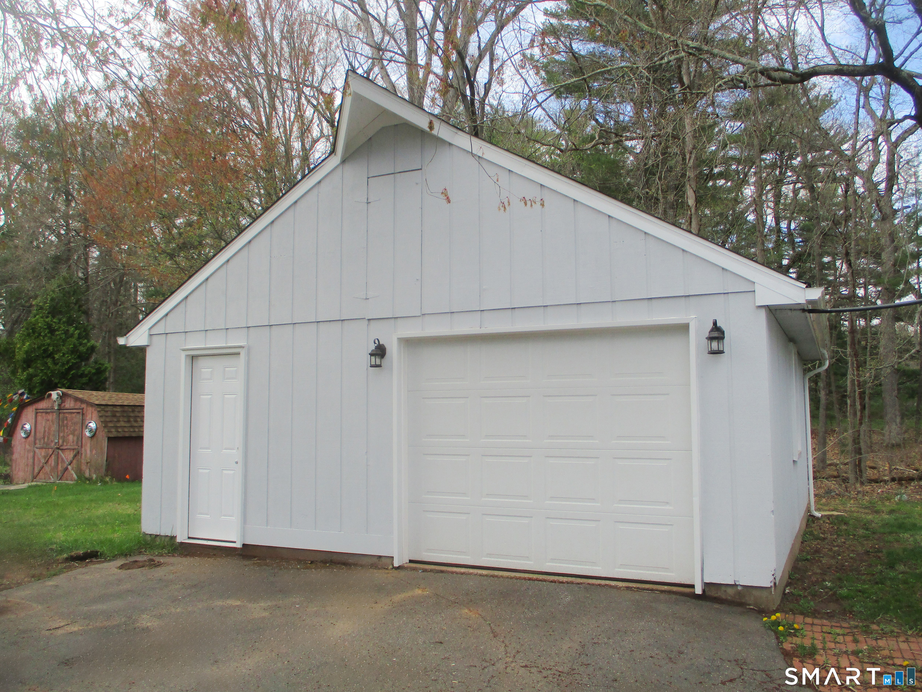 62 Rice Road East Windsor, CT 06016 - Photo 3 of 14 a view of a white house with a large tree and wooden fence