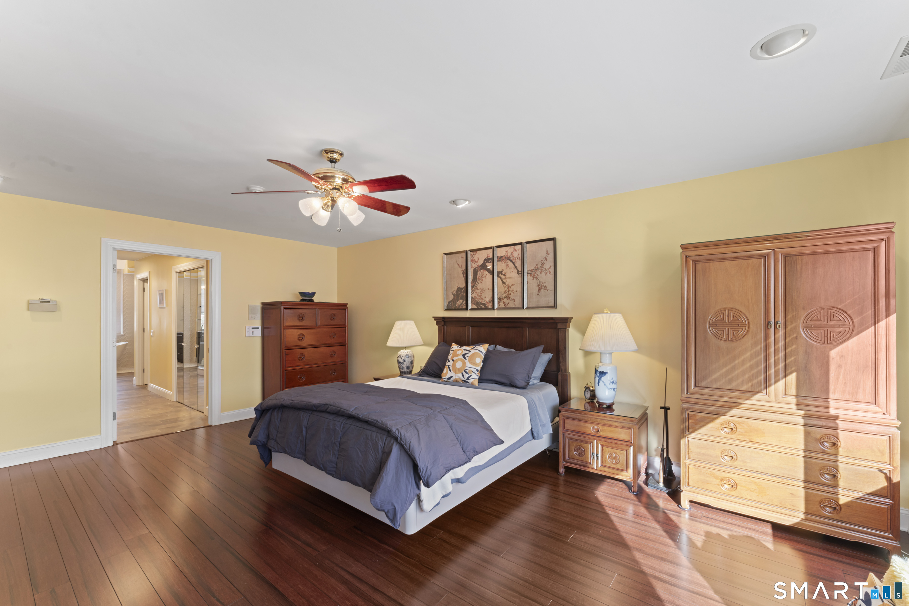 8 Cornerstone Court Ridgefield, CT 06877 - Photo 16 of 40 a bedroom with a bed and wooden floor