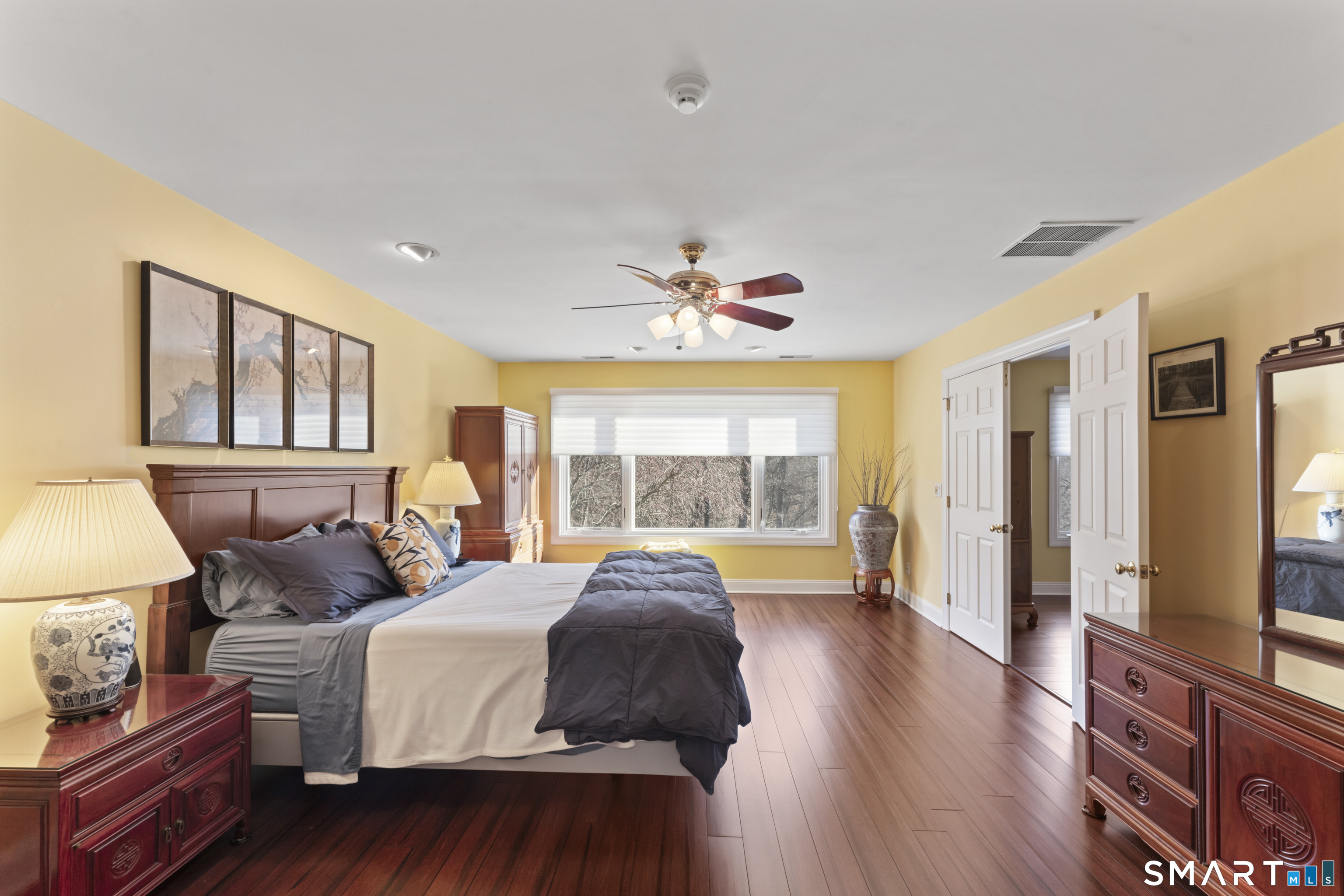 8 Cornerstone Court Ridgefield, CT 06877 - Photo 17 of 40 a spacious bedroom with a bed and wooden floor