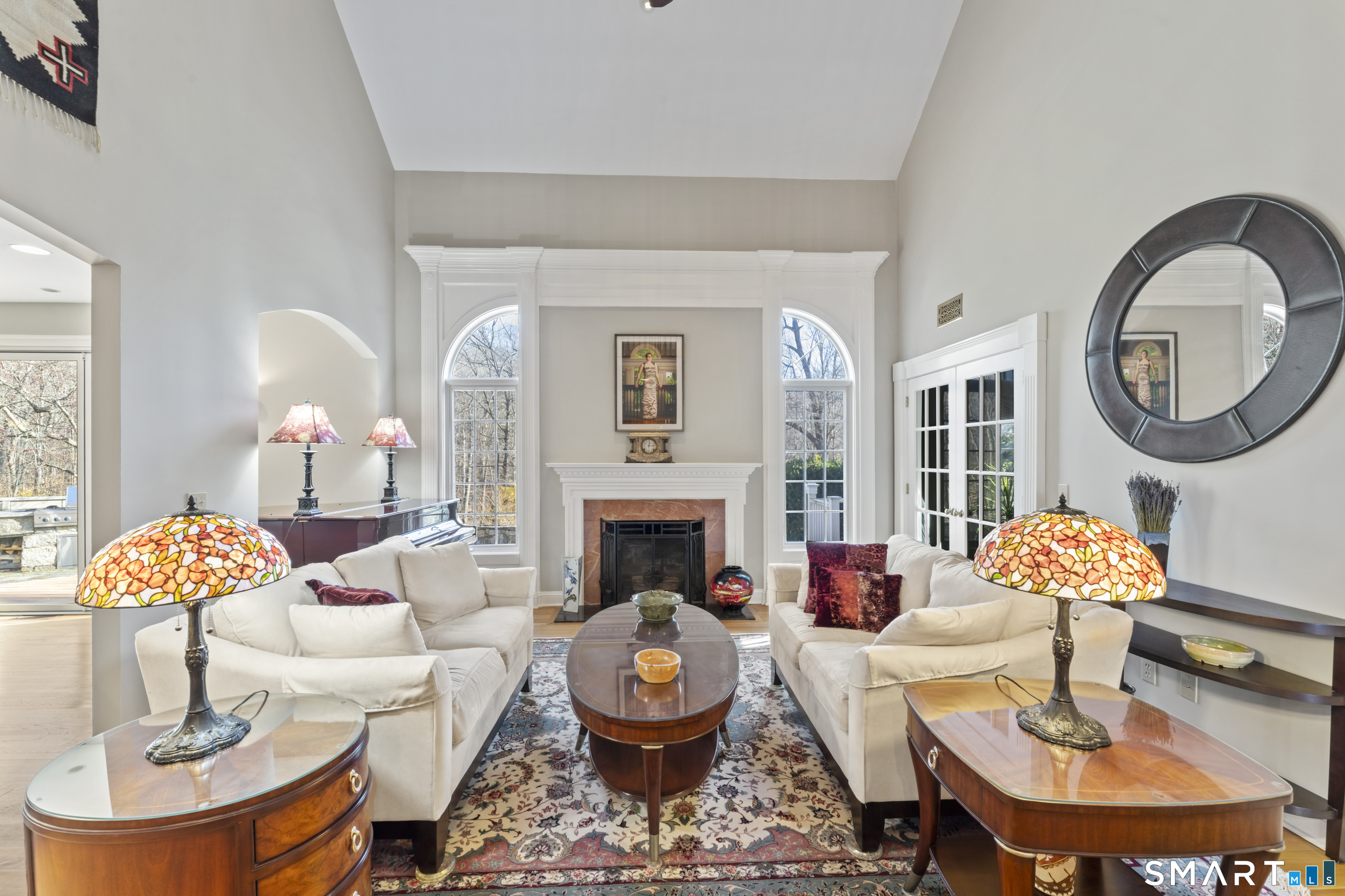 8 Cornerstone Court Ridgefield, CT 06877 - Photo 31 of 40 a living room with fireplace a fireplace and a table
