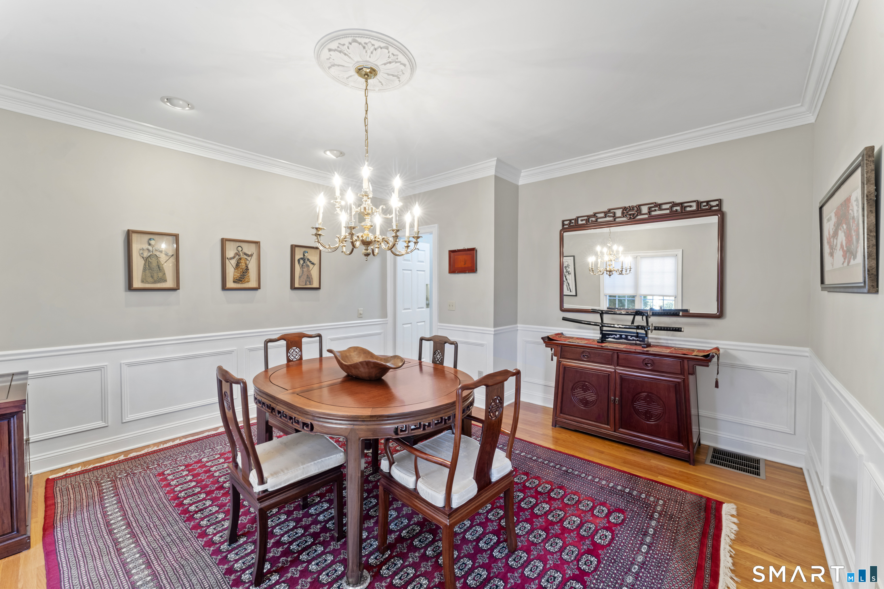 8 Cornerstone Court Ridgefield, CT 06877 - Photo 6 of 40 a dining room with a wooden table and chairs