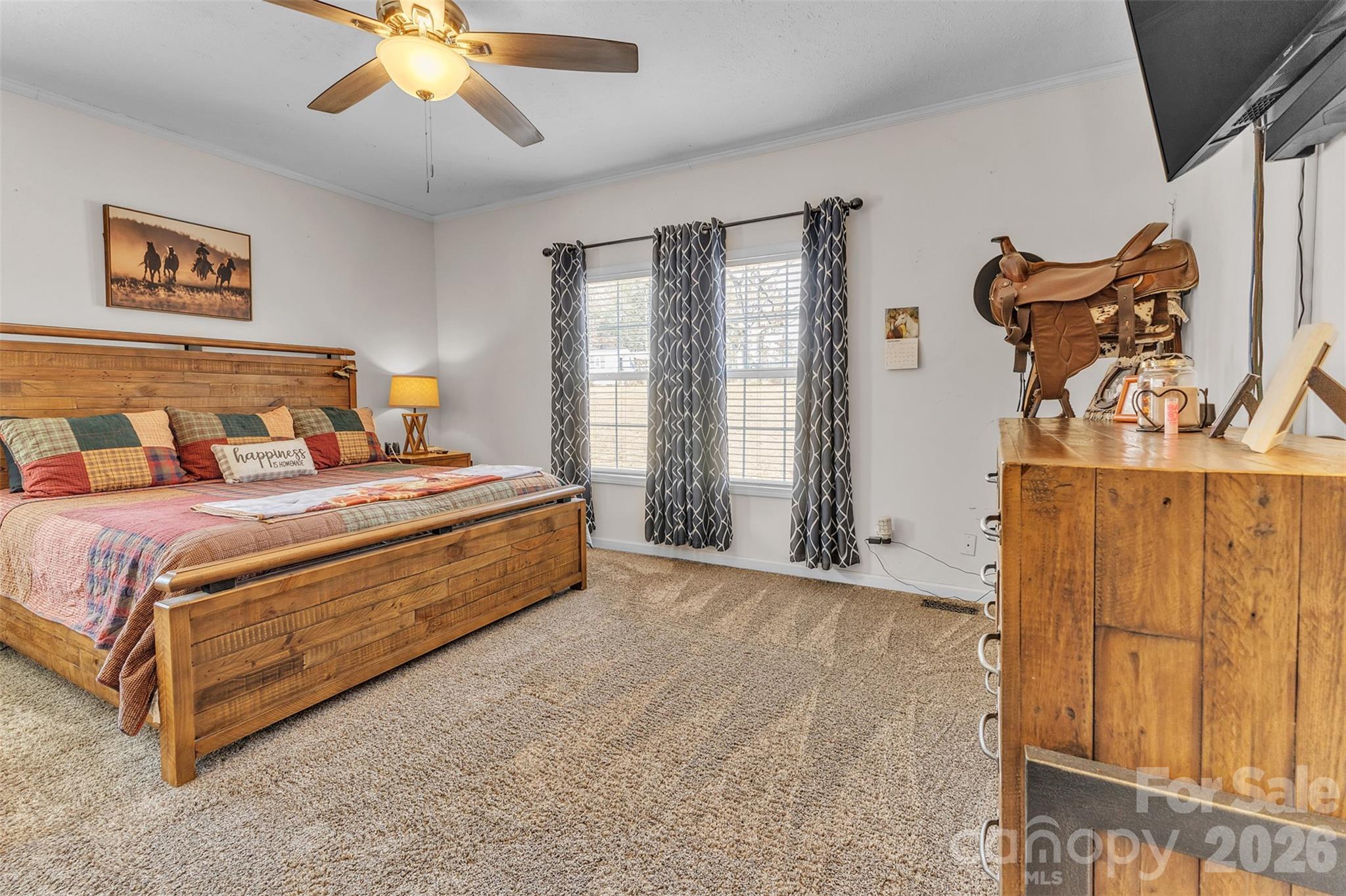 72 Crouch Road Taylorsville, NC 28681 - Photo 15 of 48 a spacious bedroom with a bed and a chandelier