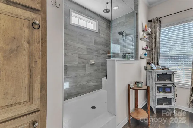a bathroom with a bathtub and a shower