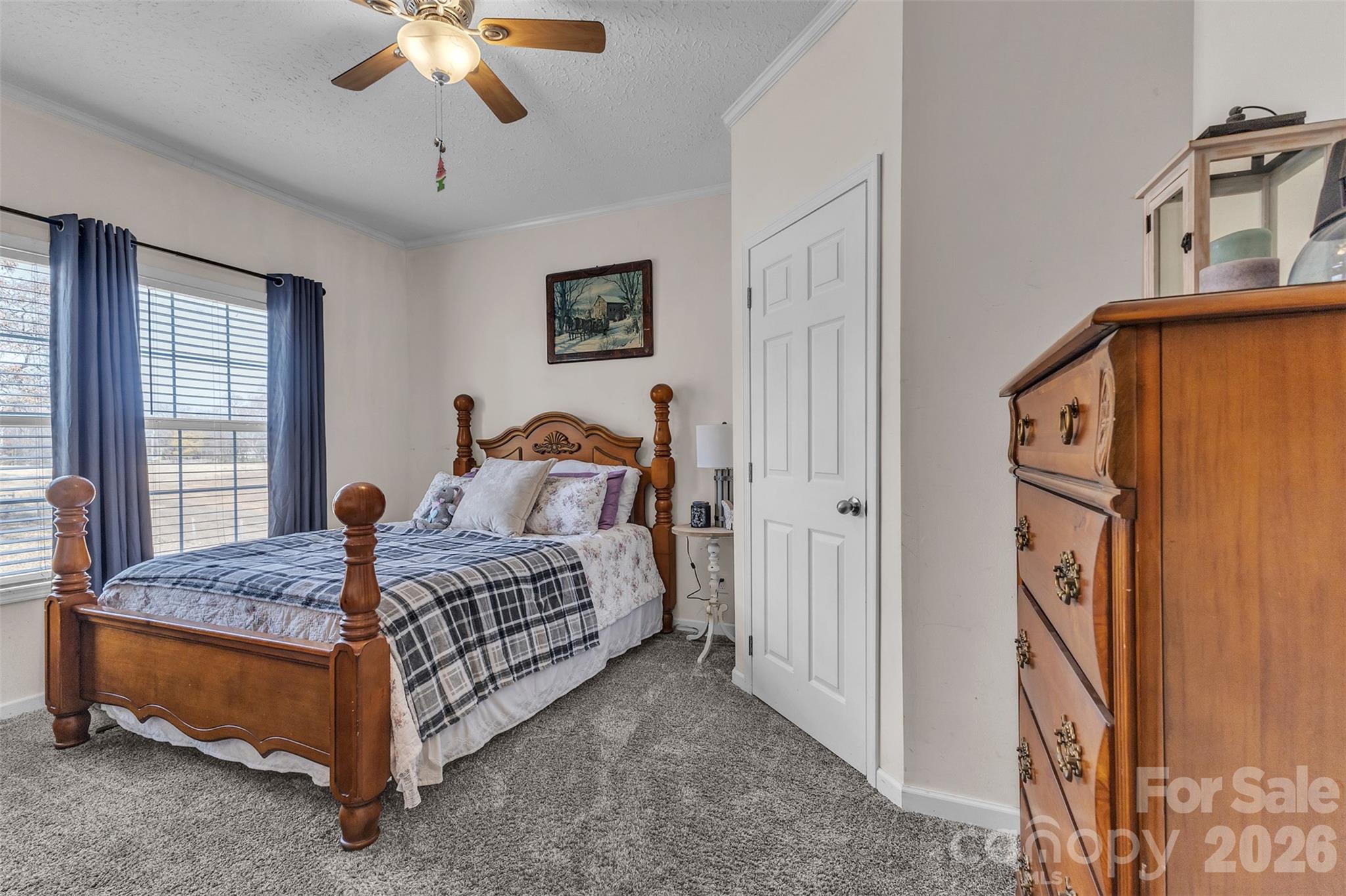 72 Crouch Road Taylorsville, NC 28681 - Photo 24 of 48 a bedroom with a bed and a chandelier