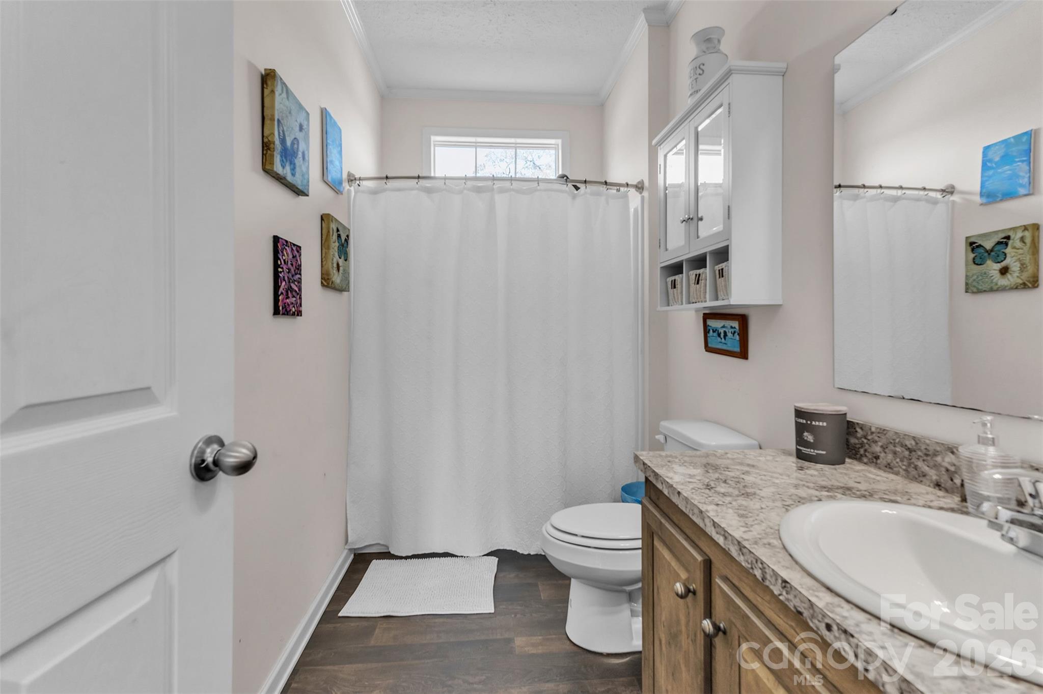 72 Crouch Road Taylorsville, NC 28681 - Photo 26 of 48 a bathroom with a granite countertop sink a toilet and a mirror