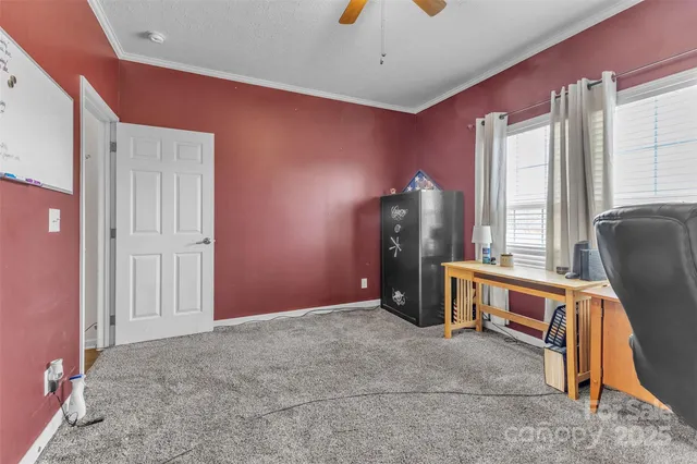 a view of work space with windows and furniture