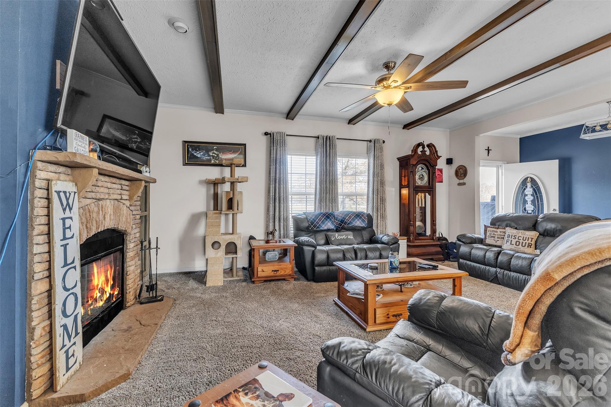 72 Crouch Road Taylorsville, NC 28681 - Photo 5 of 48 a living room with furniture a fireplace and a flat screen tv