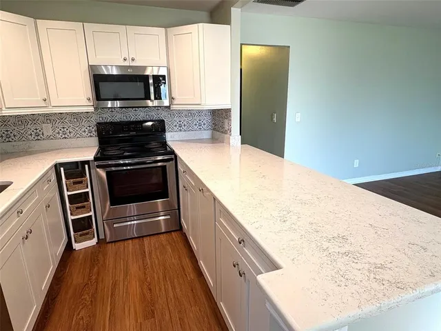 a view of a room with wooden floor