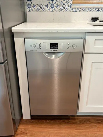 a metallic refrigerator freezer sitting in a kitchen