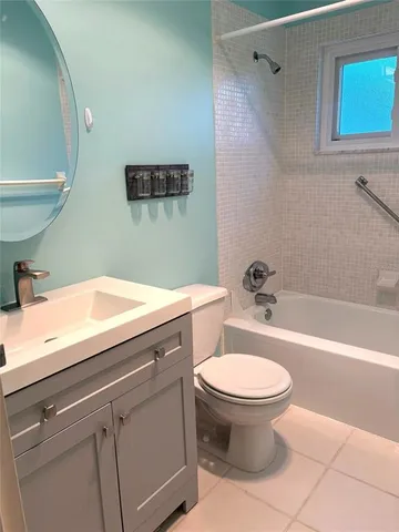 a bathroom with a sink mirror and toilet