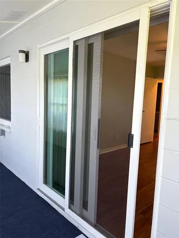 an aerial view of a swimming pool with outdoor seating
