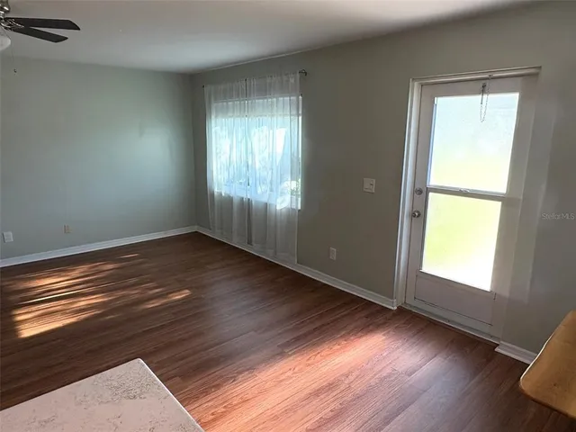 a kitchen with stainless steel appliances a stove a sink a microwave a refrigerator and cabinets