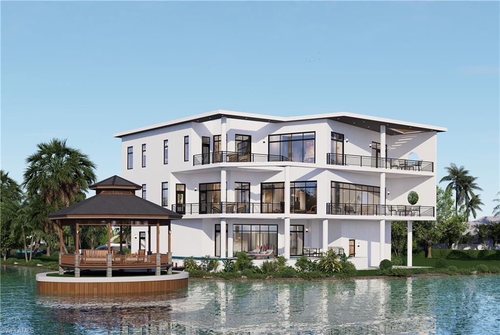 a front view of a house with a lake view and large trees