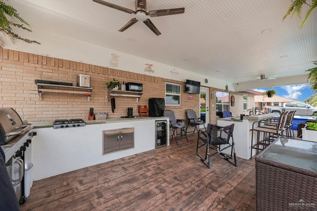 400 Taurus Street Mission, TX 78572 - Photo 15 of 16 View of patio with an outdoor kitchen, a ceiling fan, and beverage cooler