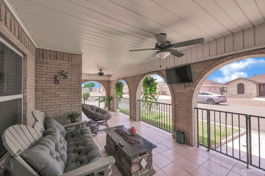 400 Taurus Street Mission, TX 78572 - Photo 2 of 16 View of patio featuring ceiling fan and an outdoor living space with a fire pit