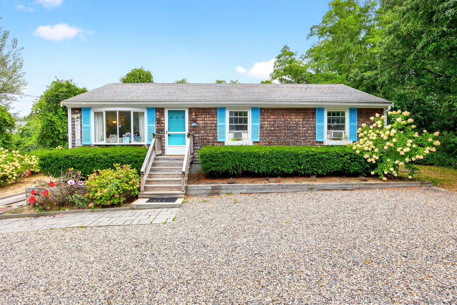 4 Coffey Lane Dennis Port, MA 02639 - Photo 5 of 48 a front view of a house with a garden