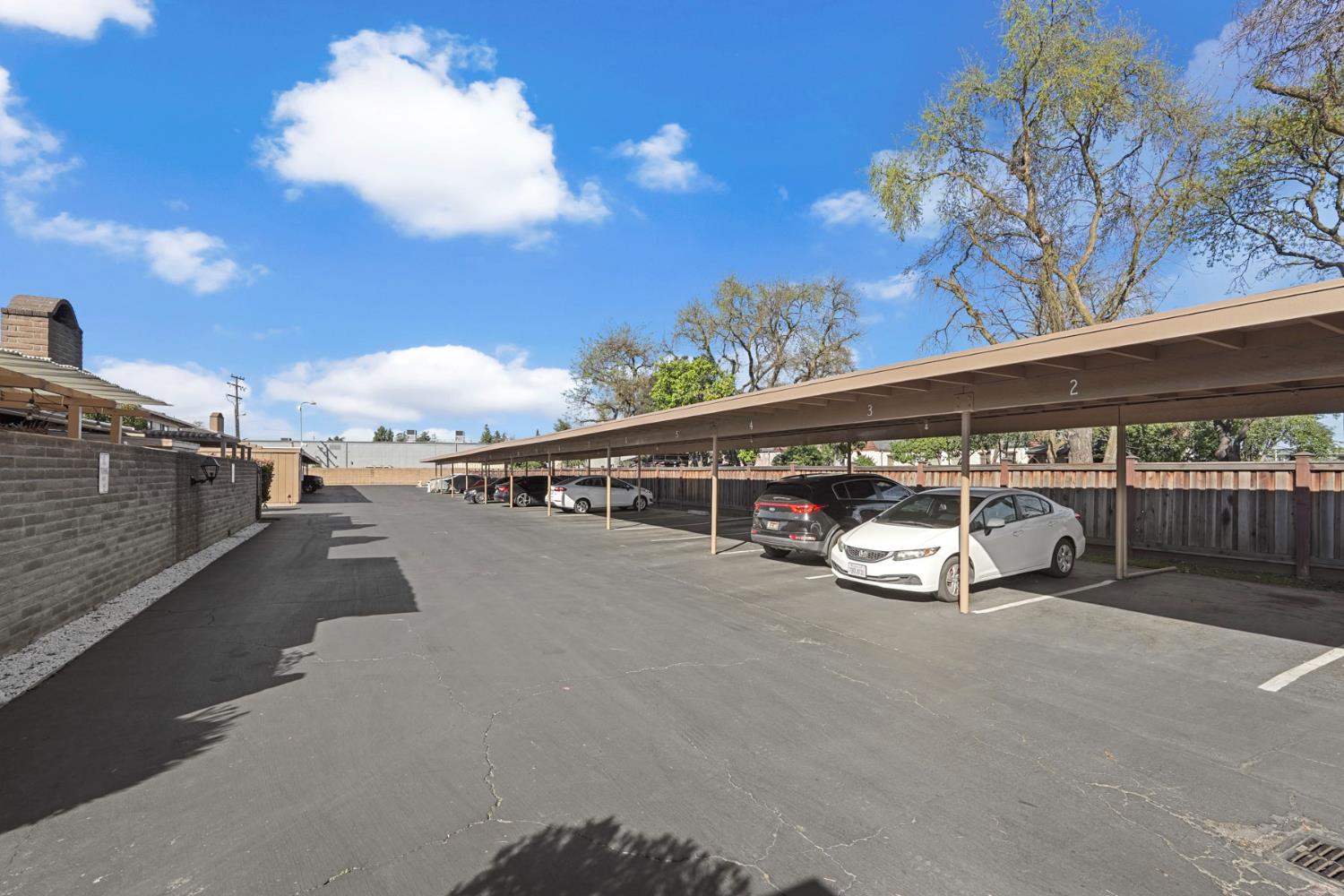 1077 Rivara Road, Unit 104 Stockton, CA 95207 - Photo 22 of 25 Assigned covered parking spaces behind the gate