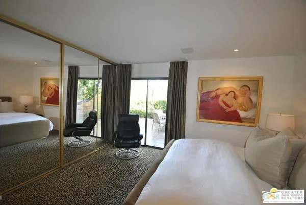 a living room with couch cabinet and a large window