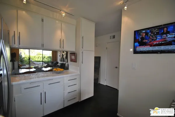 a kitchen with white cabinets and a sink