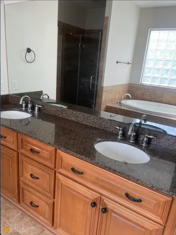 a bathroom with sink granite and mirror